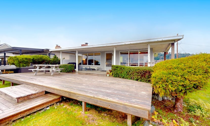 Charming waterfront home with expansive deck & gorgeous sunset views