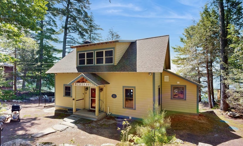 Captivating lakefront home with private dock, row boat, firepit, and lake views