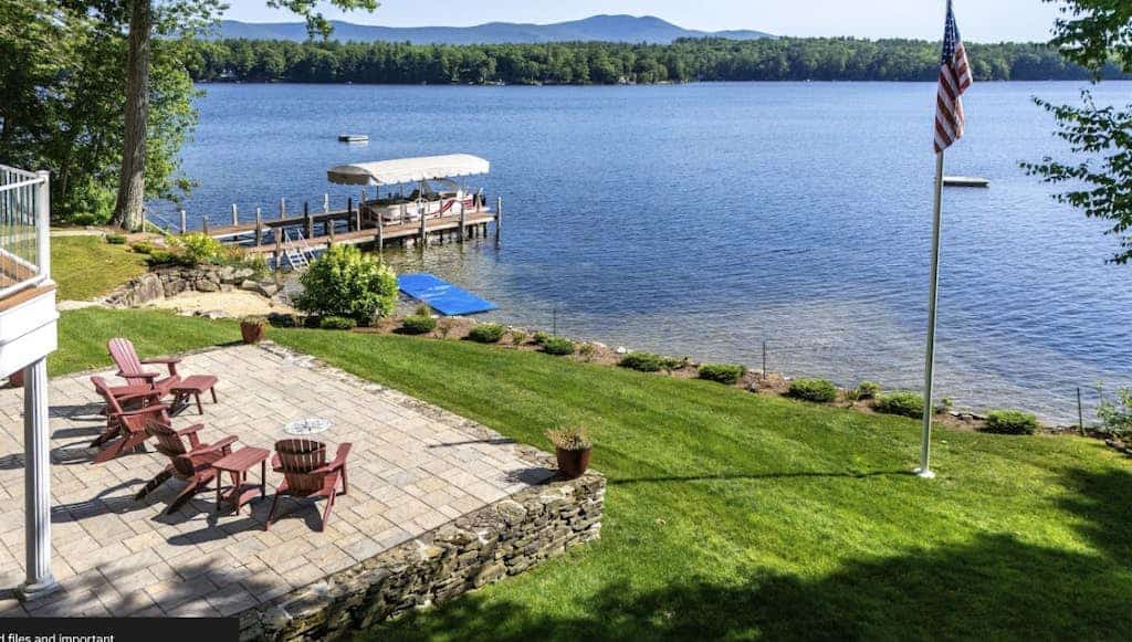 Stunning lakefront property with beach access, a dock, spacious yard, & W/D