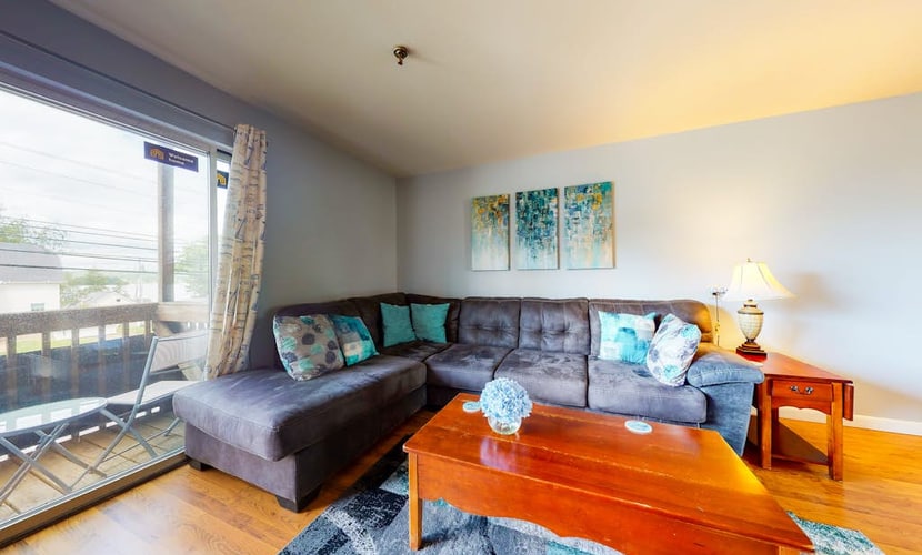 Inviting condo in quiet locale with partial lake views, balcony & grilling area