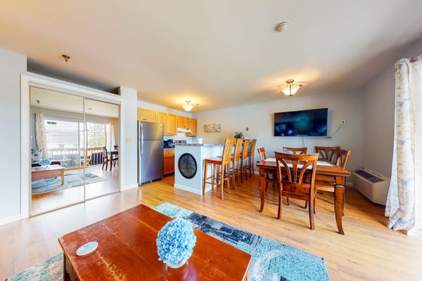Inviting condo in quiet locale with partial lake views, balcony & grilling area