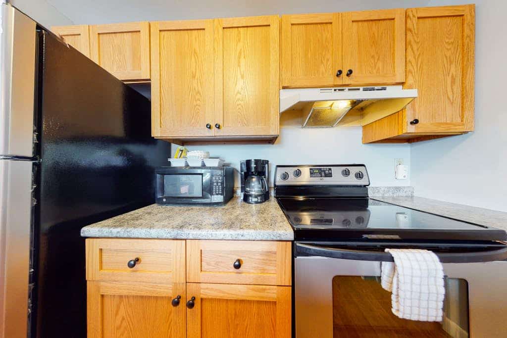 Inviting condo in quiet locale with partial lake views, balcony & grilling area
