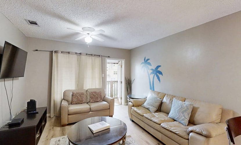 Second-floor condo 1/2 block from the beach with pool, central AC & W/D