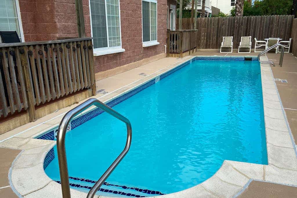 Second-floor condo 1/2 block from the beach with pool, central AC & W/D