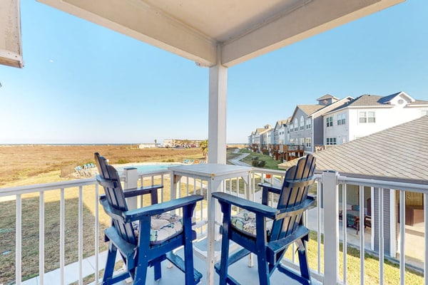 Modern, second-floor condo steps to beach with balcony, W/D, & pool access