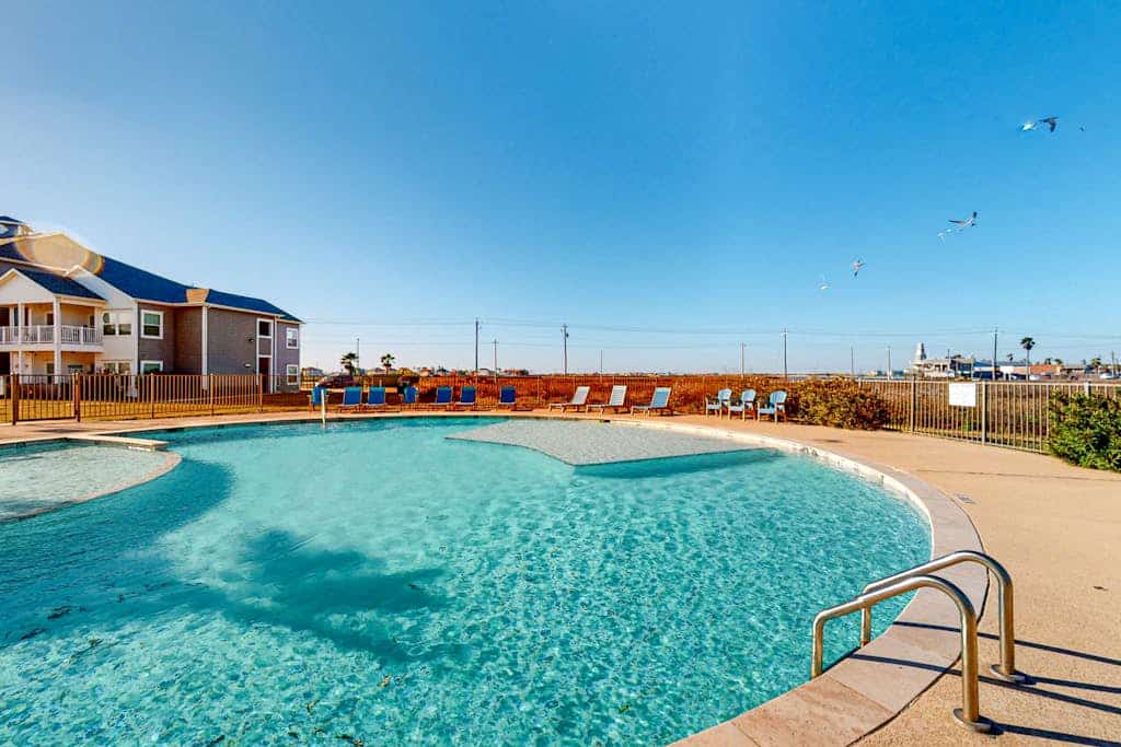 Modern, second-floor condo steps to beach with balcony, W/D, & pool access