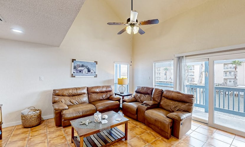 Canal-front condo with dock, hot tub, pool, BBQ area, cabana, water views, W/D
