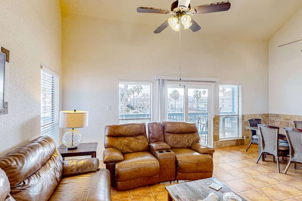Canal-front condo with dock, hot tub, pool, BBQ area, cabana, water views, W/D