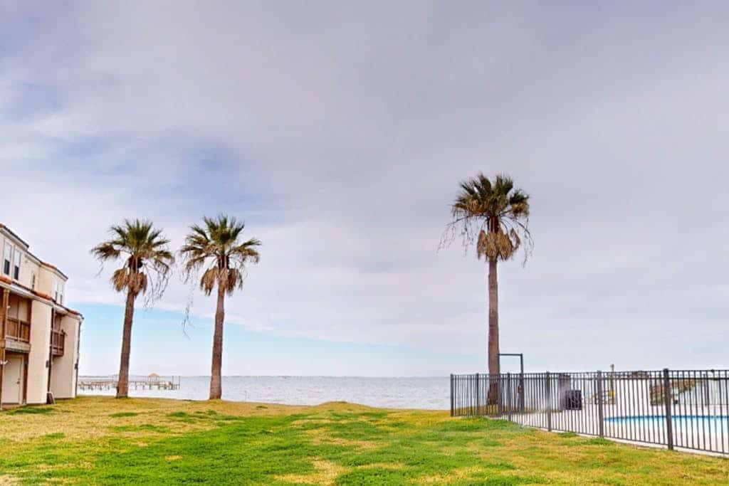 Waterfront condo with bay view, outdoor pool, tennis, dock, balcony, W/D, & AC