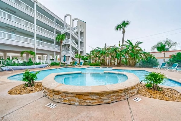 Beach-view condo steps from Babe’s Beach with pool, hot tub, balcony, & W/D