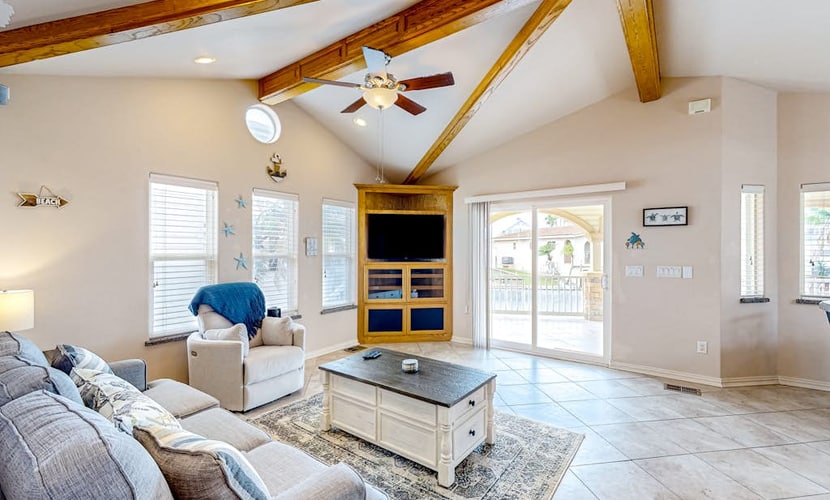 Single-level waterfront retreat with a furnished patio, AC, & washer/dryer