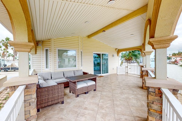 Single-level waterfront retreat with a furnished patio, AC, & washer/dryer
