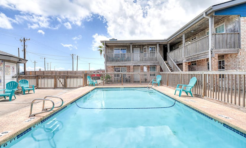 Coastal Bend condo with pool, boat slips, & fishing dock - walk to beach