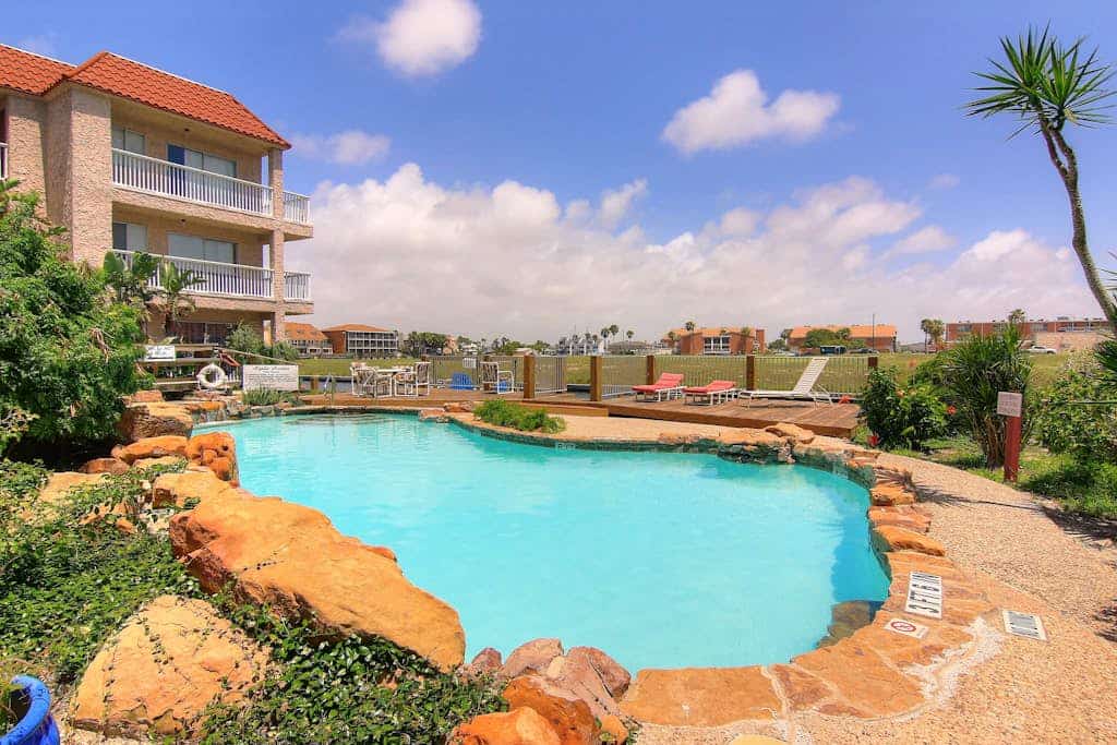 First-floor condo near Whitecap Beach with balcony, pool & dock