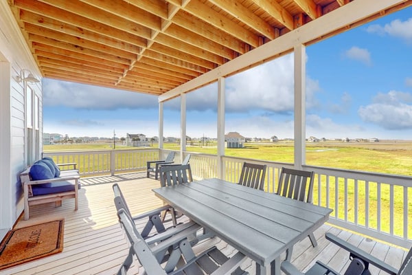 Brand new coastal gem with bay/wetland views, two balconies, & outdoor shower