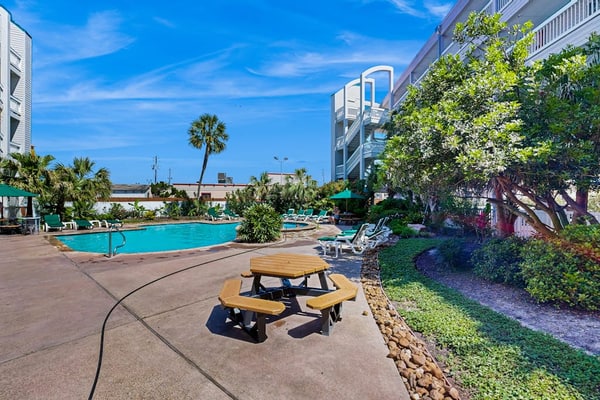 1st-floor condo with balcony, on-site pool, washer/dryer, grills, outdoor shower