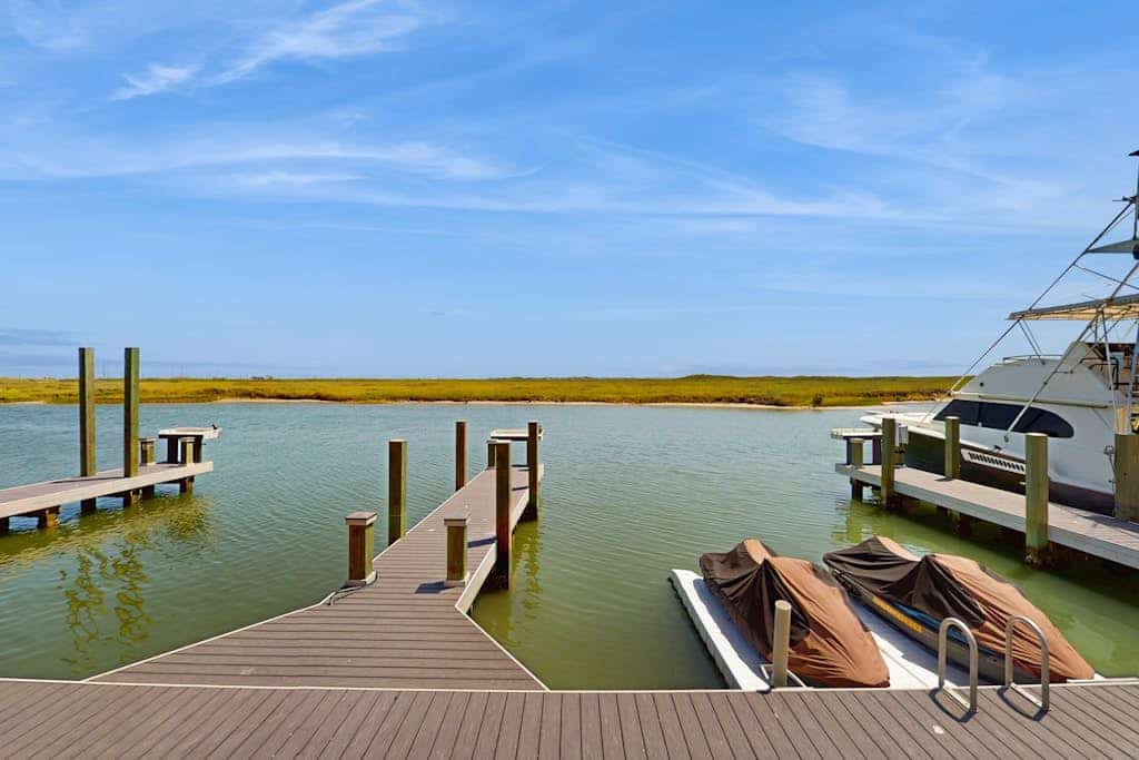 Waterfront townhome with dock, canal view & fireplaces - walk to beach