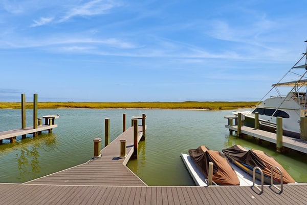 Waterfront townhome with dock, canal view & fireplaces - walk to beach