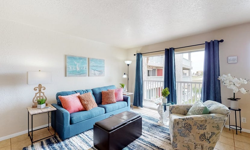 Coastal Bend condo with water views, dock, pool, sun deck, balcony, & W/D