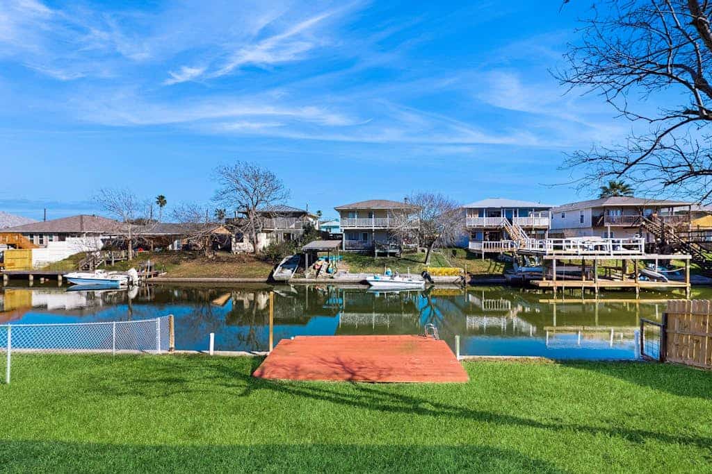 Stunning waterfront home on the canal with large yard & covered patio