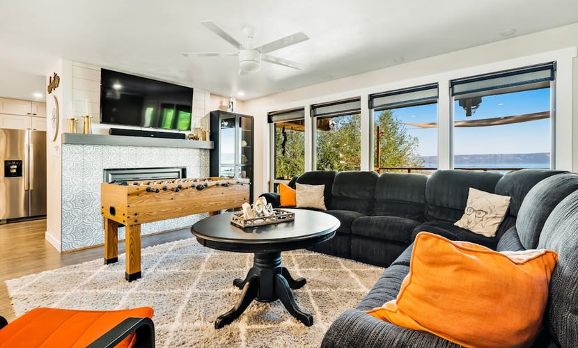 Single-level, lakefront getaway with mini-bar, furnished deck & mountain views
