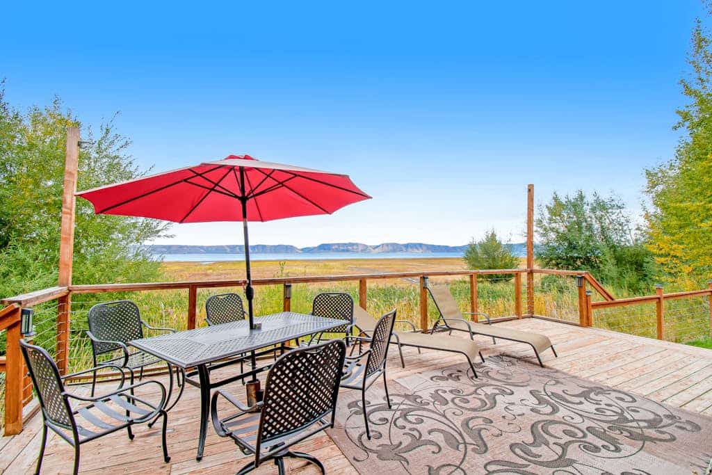 Single-level, lakefront getaway with mini-bar, furnished deck & mountain views