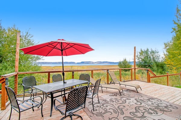 Single-level, lakefront getaway with mini-bar, furnished deck & mountain views