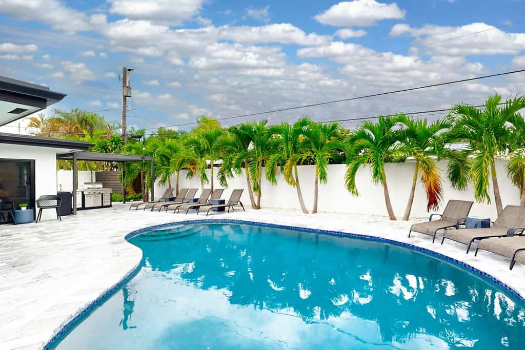 Stunning single level home with, heated pool, kitchen, & fully equipped BBQ area