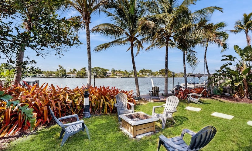 Inviting waterfront home with pool, enclosed yard, firepit, W/D, & dog-friendly