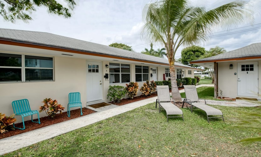 Modern condo near towering palms with beach decor, grill, & yard - walk to beach
