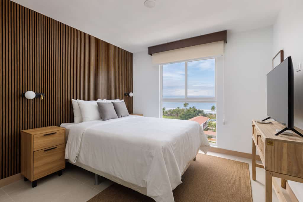 Welcome to our vibrant ocean view condo-high floor, perfect for family getaways! Nestled just a short stroll from the heart of Jaco, this modern oasis boasts stunning ocean views and a playful, colorful decor that creates a joyful and relaxing atmosphere. Ideal for families with children, our condo features two spacious bedrooms designed with comfort and fun in mind. The open-plan living area is bright and inviting, offering plenty of space for quality time together. Enjoy the convenience of being steps away from the beach, where you can build sandcastles or take a refreshing dip in the sea. With its prime location near Jaco's central attractions, you'll have easy access to local dining, shopping, and entertainment. Experience the perfect blend of modern style and coastal charm in our delightful condo. We look forward to hosting you and ensuring your stay is memorable and enjoyable!