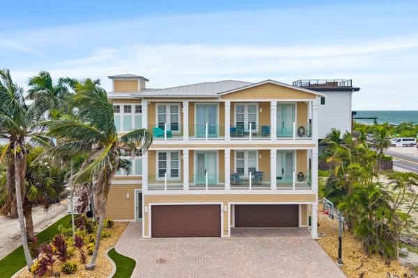 Welcome to The Pearl, a luxurious oceanfront Anna Maria Island vacation home where white-sand beaches and historic charm are just steps from your front door.
This 6-bedroom home is divided into two apartments with 3-bedrooms and 2.5 baths each, giving your large group plenty of space and privacy. Each floor offers unique and cozy coastal decor, an open-floor plan living room, secondary bedrooms sharing a Jack-and-Jill bath, and a primary suite with a king-sized bed, private oceanview balcony, and spa bath with garden tub. Unit B is on the 3rd floor, with both elevator and stair access.
The expansive backyard offers plenty of shaded space for dining and relaxing, along with an outdoor television, heated pool, and putting green.
Prepare and enjoy family meals in the stocked, ocean-view kitchen and informal dining room, or take advantage of shaded outdoor dining on the patio. Not in the mood to cook? Local favorites are just three blocks away at Historic Bridge Street, the epicenter of South AMI dining and nightlife.
When its time for the beach, you'll have everything you need, including towels, chairs, and umbrellas.
Key Features & Highlights:
Prime Location: This Anna Maria Island vacation home is located directly across the street from Cortez Beach, putting you just steps away from the ocean. Historic Bridge Street's dining, shopping and nightlife are just three blocks away.
Light & Airy Living: Open-concept living space designed for gathering with family or friends offers ocean views from the kitchen, dining nook, living room, and primary bedroom.
Beach Ready: Beach gear included so you can sink your toes into the sand from day one!
Book now and see why this expansive oceanview vacation home is truly The Pearl of Anna Maria Island.
