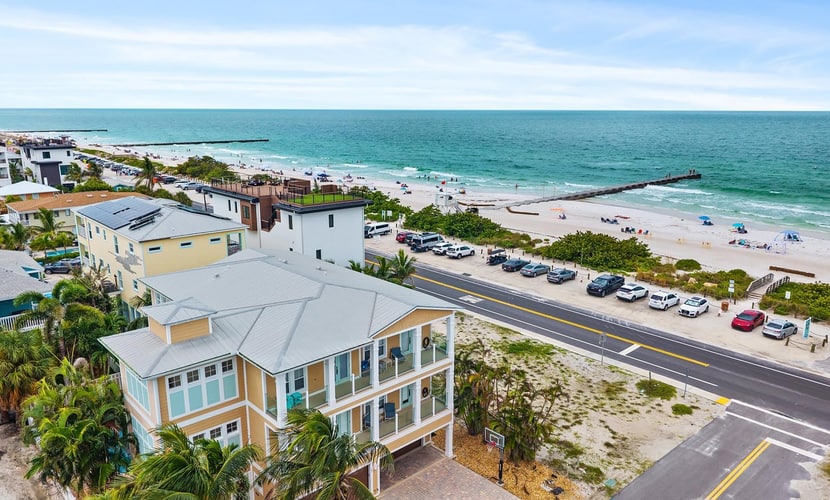 Welcome to The Pearl, a luxurious oceanfront Anna Maria Island vacation home where white-sand beaches and historic charm are just steps from your front door.
This 6-bedroom home is divided into two apartments with 3-bedrooms and 2.5 baths each, giving your large group plenty of space and privacy. Each floor offers unique and cozy coastal decor, an open-floor plan living room, secondary bedrooms sharing a Jack-and-Jill bath, and a primary suite with a king-sized bed, private oceanview balcony, and spa bath with garden tub. Unit B is on the 3rd floor, with both elevator and stair access.
The expansive backyard offers plenty of shaded space for dining and relaxing, along with an outdoor television, heated pool, and putting green.
Prepare and enjoy family meals in the stocked, ocean-view kitchen and informal dining room, or take advantage of shaded outdoor dining on the patio. Not in the mood to cook? Local favorites are just three blocks away at Historic Bridge Street, the epicenter of South AMI dining and nightlife.
When its time for the beach, you'll have everything you need, including towels, chairs, and umbrellas.
Key Features & Highlights:
Prime Location: This Anna Maria Island vacation home is located directly across the street from Cortez Beach, putting you just steps away from the ocean. Historic Bridge Street's dining, shopping and nightlife are just three blocks away.
Light & Airy Living: Open-concept living space designed for gathering with family or friends offers ocean views from the kitchen, dining nook, living room, and primary bedroom.
Beach Ready: Beach gear included so you can sink your toes into the sand from day one!
Book now and see why this expansive oceanview vacation home is truly The Pearl of Anna Maria Island.