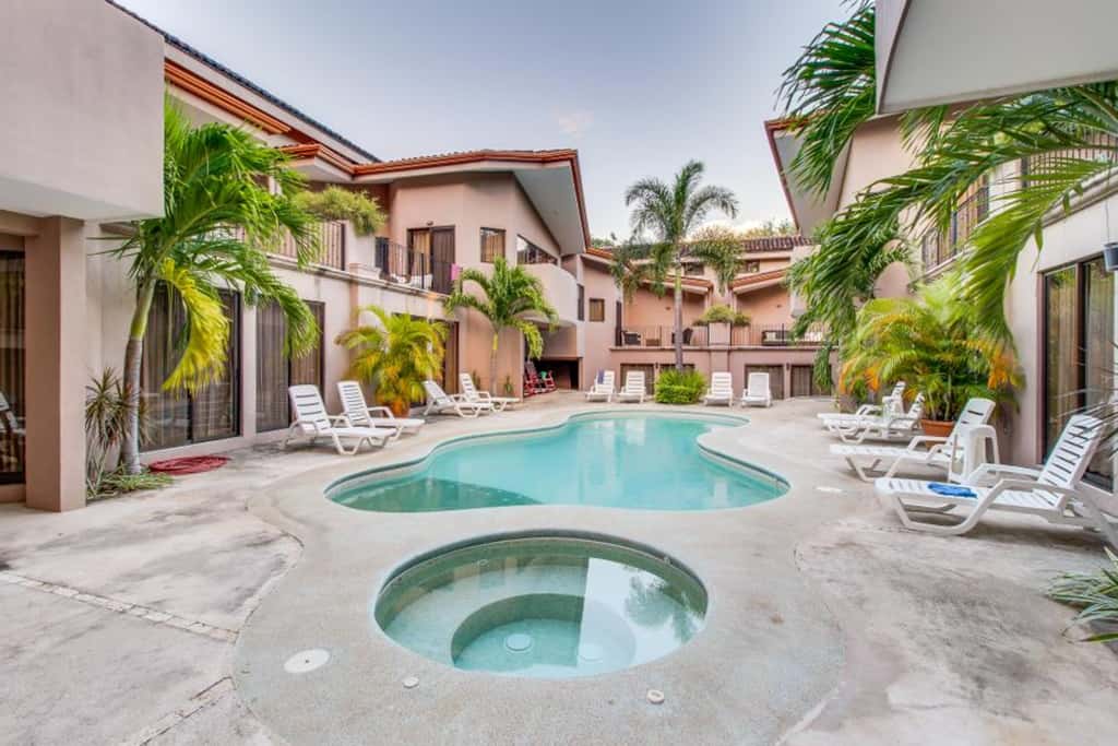 Sunny 2BR: Balcony, Pool, Kitchen, Walk to Beach