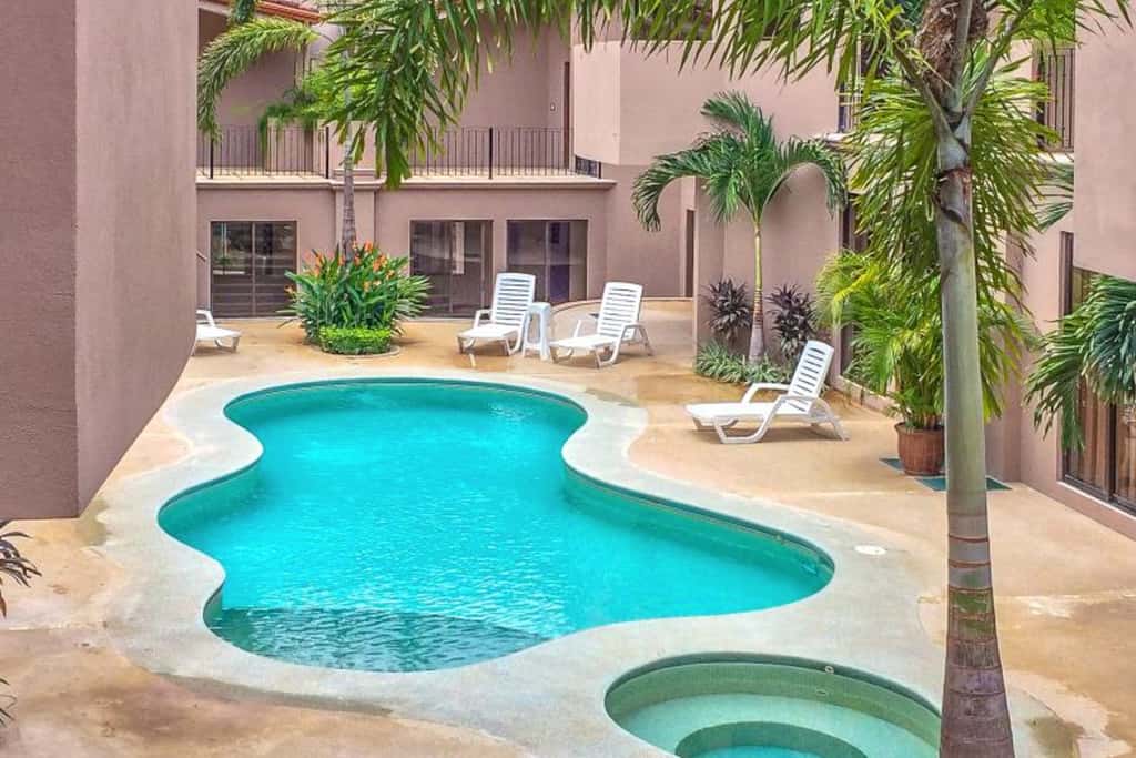 Sunny 2BR: Balcony, Pool, Kitchen, Walk to Beach