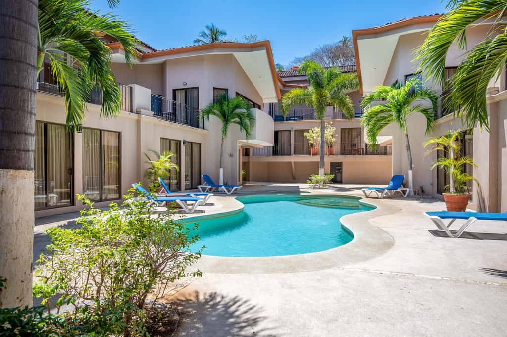 Sunny 2BR: Balcony, Pool, Kitchen, Walk to Beach