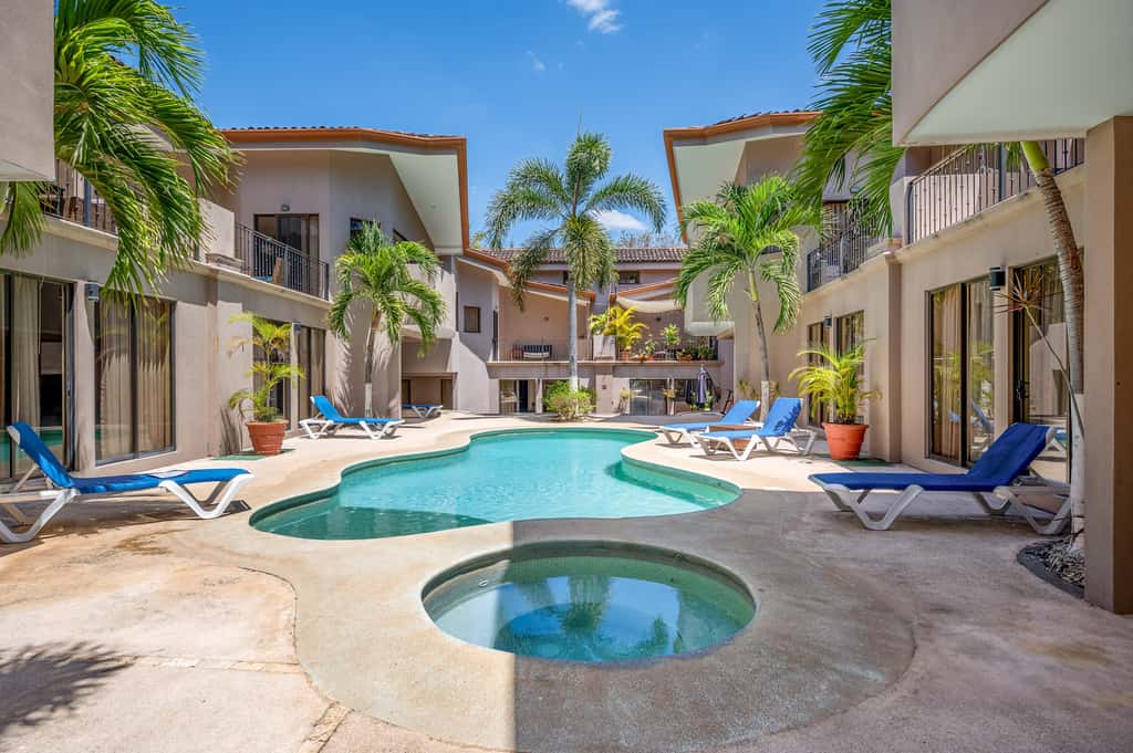 Sunny 2BR: Balcony, Pool, Kitchen, Walk to Beach