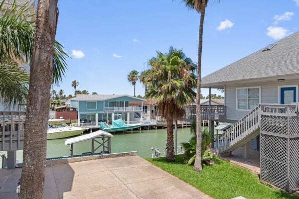 Welcome to Casa de Cielos Azure, a waterfront retreat in Long Island Village, a gated resort community on the Laguna Madre just minutes from South Padre Island. Fish from the private dock, take in the water from wraparound covered decks, and cook in a chef's kitchen with quartz counters. Four bedrooms and four full baths sleep 8, with resort pools, hot tubs, golf, tennis, mini golf, and a marina all inside the gates. On launch days, watch SpaceX light up the sky across the water.