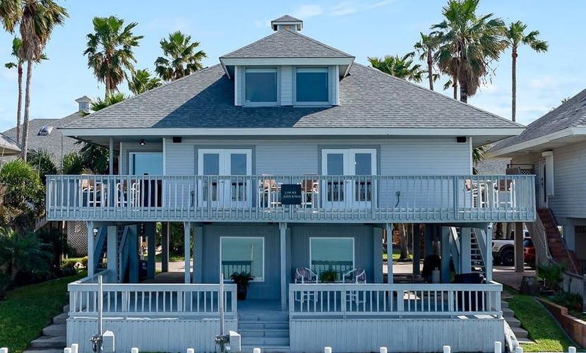 Welcome to Casa de Cielos Azure, a waterfront retreat in Long Island Village, a gated resort community on the Laguna Madre just minutes from South Padre Island. Fish from the private dock, take in the water from wraparound covered decks, and cook in a chef's kitchen with quartz counters. Four bedrooms and four full baths sleep 8, with resort pools, hot tubs, golf, tennis, mini golf, and a marina all inside the gates. On launch days, watch SpaceX light up the sky across the water.