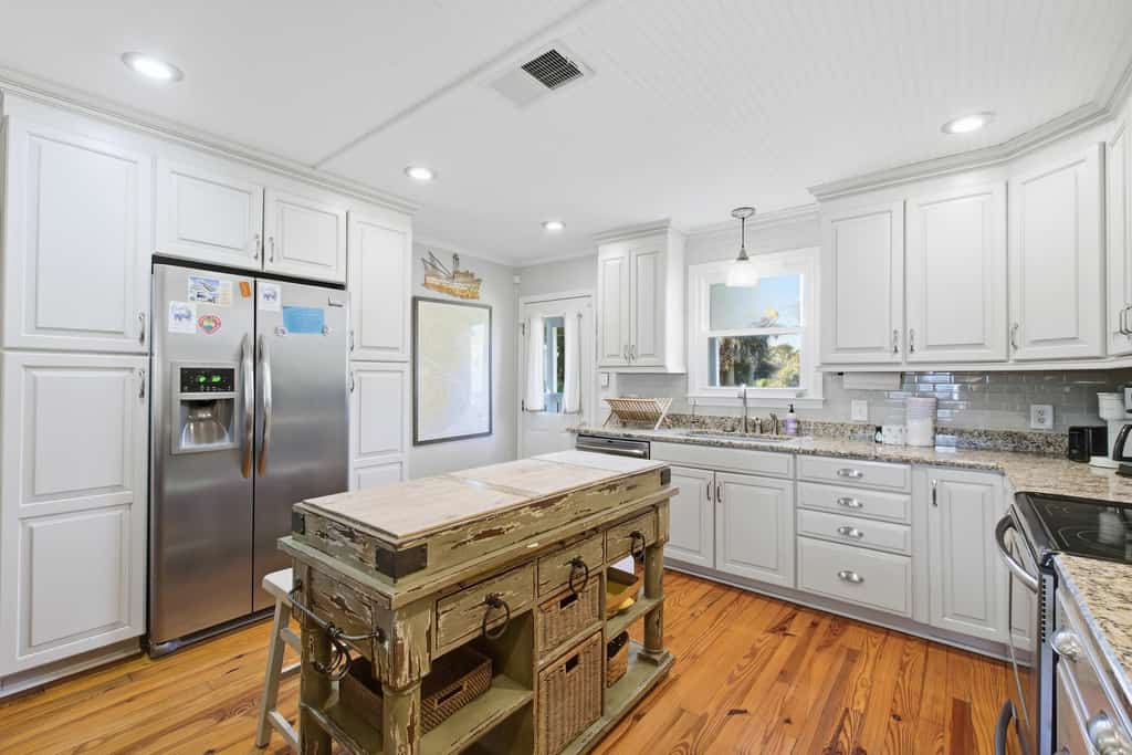 Edisto Beach Getaway is a charming 4-bedroom, 2-bath classic beach cottage tucked away on a quiet, tree-lined street just a short walk from the ocean. Sleeping up to 10 guests, this cozy retreat combines timeless coastal charm with modern comforts, making it an ideal getaway for families and groups.

Enjoy a spacious yard, ample parking for cars and boats, a relaxing screened porch, an enclosed outdoor shower, and a comfortable under-house gathering area. Inside, the open-concept living, dining, and kitchen space provides plenty of room for everyone to relax, dine, and spend quality time together.

Whether you're heading to the beach, enjoying a morning coffee on the porch, or gathering with family after a day in the sun, Edisto Escape offers the laid-back beach experience you've been looking for.