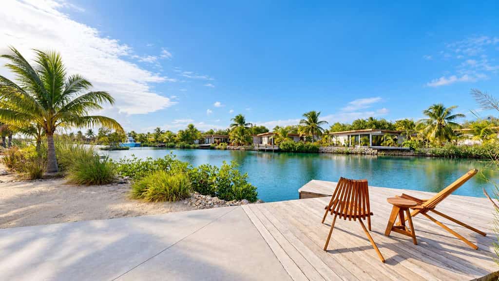 Stay lagoonfront at Seabird, an exclusive boutique community in Placencia. This three-bedroom villa for up to six guests features a private plunge pool and dock, inviting indoor-outdoor living, and access to Seabird's shared community pool and amenities.