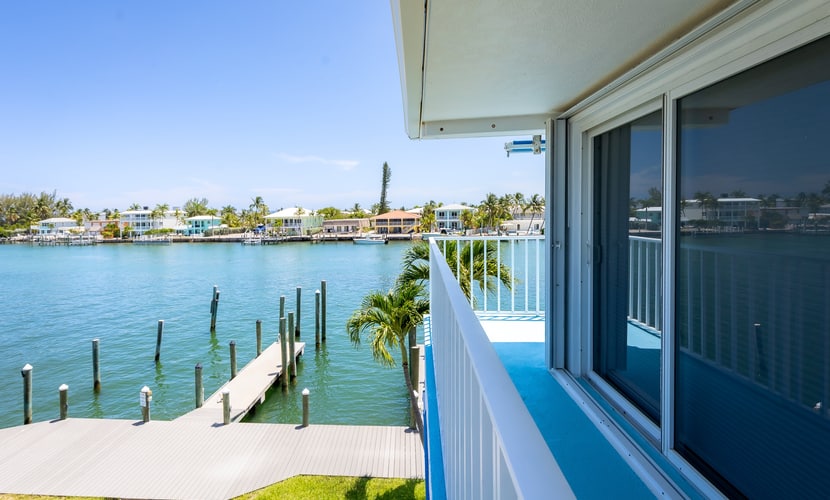 Oceanfront 3BR condo with water views, pool, and boat dock.