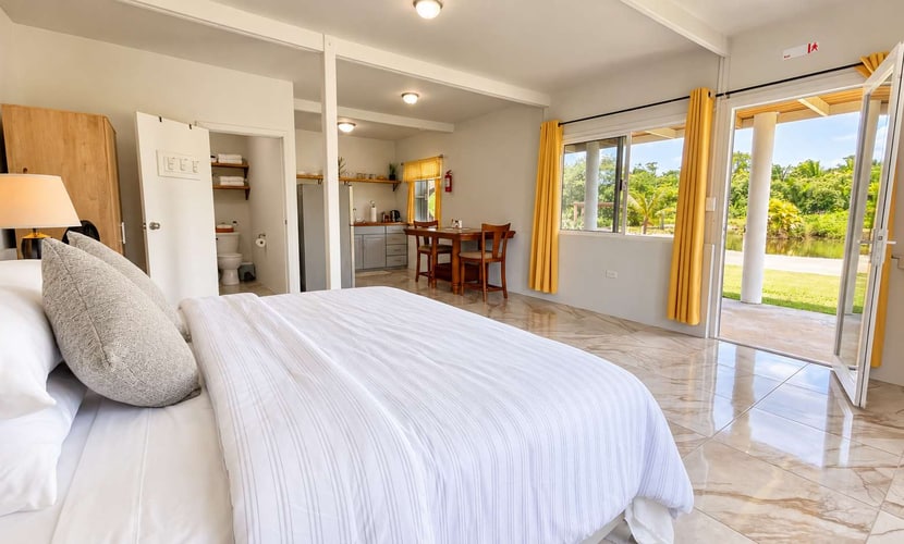 Enjoy modern comfort surrounded by nature at Suburbia Guest House, a peaceful Belmopan studio for two with a private pond, scenic upper deck, king bed, and full kitchen. Relax among tropical greenery while enjoying a comfortable base for exploring Belmopan and the Cayo District.