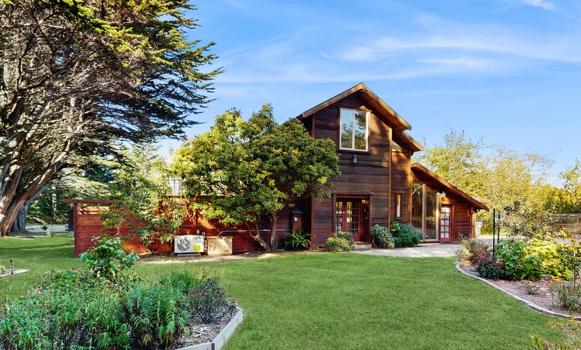 Welcome to Cypress Garden House, a distinctive architectural retreat surrounded by lush gardens on the Mendocino Coast. Just minutes from Mendocino Village, Russian Gulch State Park and some of the area’s most scenic coastline, this custom-built home blends open, airy design with comfortable spaces for relaxing, cooking and spending time outdoors.
Vaulted ceilings, exposed beams, expansive windows and radiant-heated floors create a warm, modern atmosphere. Outside, a spacious redwood deck features a private sunken cedar hot tub, multiple seating areas and an enclosed yard for dogs.