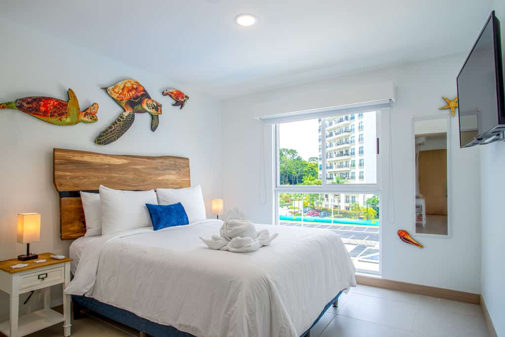 Welcome to your stylish coastal escape! This modern condo, just 3 minutes from vibrant Jaco, blends contemporary comfort with beach-inspired charm. Featuring sleek furnishings and marine-themed decor, the open-concept living area boasts expansive windows that frame stunning resort views.
The fully equipped kitchen includes high-end appliances and chic countertops, ideal for preparing meals. The adjacent dining and living spaces are perfect for relaxing or entertaining. Each luxurious bedroom offers plush bedding and serene views of the resort, ensuring a restful stay.
Step onto your private balcony to enjoy morning coffee or evening drinks with breathtaking sunsets. The complex includes exceptional amenities: three sparkling pools, a BBQ area, a state-of-the-art gym, and a versatile meeting room.
With Jaco’s vibrant nightlife, trendy shops, and dining options just a short drive away, this condo offers the ideal mix of relaxation and convenience. Book now to experience modern elegance, spectacular views, and unmatched comfort in your perfect beachfront retreat.
