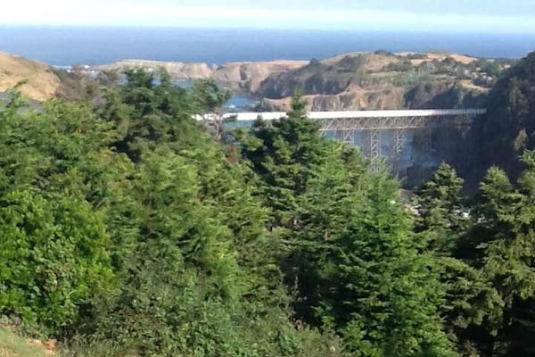 This stunning custom home was built to take full advantage of its ridge-top views of the Albion River and Pacific Ocean. The great room, primary bedroom and secondary bedroom all feature spectacular views of the ocean and the Albion River Bridge, the largest wood trestle bridge remaining in California.
With Starlink Wi-Fi, the home is also well suited for remote work. It is an ideal retreat for families and groups, with a spacious open great room featuring a sectional, sofa and two corner chairs positioned for enjoying beautiful coastal sunsets.
The dining table seats 8+, with three additional counter stools off the spacious, fully equipped kitchen. Guests regularly remark on how well stocked the kitchen is for family cooking and holiday stays.
The great room also features a 50-inch flat-screen TV and Baldwin piano, with two additional televisions elsewhere in the home. For entertainment, there is a pool table, darts, board games and puzzles.
The area has recently added a Verizon tower for improved cell coverage, and the home also has a landline with unlimited long-distance calling.