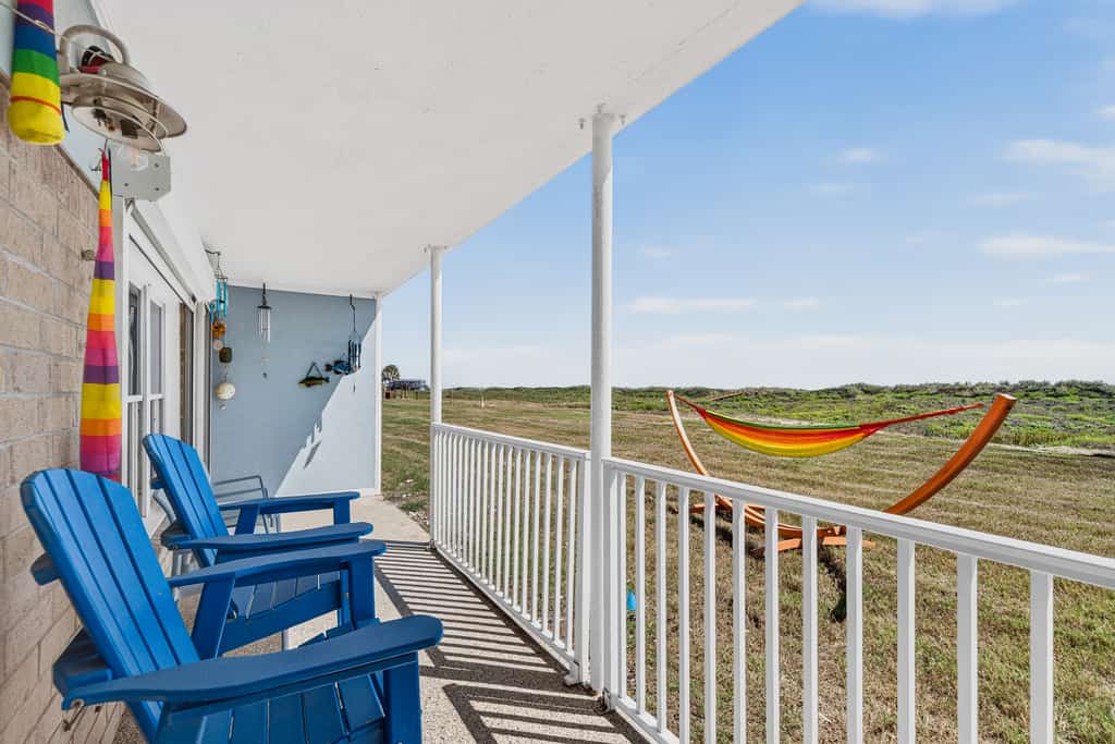 Coffee in hand, you settle into a blue Adirondack chair on your own covered patio while the hammock sways over the grass and the dunes roll out in front of you. The Love Shack is a ground floor, walk straight in condo at Island Retreat, a 25 acre beachfront community on Mustang Island. Take the private boardwalk over the dunes to the sand, then come back for the pools, tennis and pickleball. Two bedrooms, two full baths, a full kitchen, and your own washer and dryer.