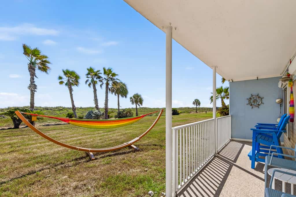 Coffee in hand, you settle into a blue Adirondack chair on your own covered patio while the hammock sways over the grass and the dunes roll out in front of you. The Love Shack is a ground floor, walk straight in condo at Island Retreat, a 25 acre beachfront community on Mustang Island. Take the private boardwalk over the dunes to the sand, then come back for the pools, tennis and pickleball. Two bedrooms, two full baths, a full kitchen, and your own washer and dryer.