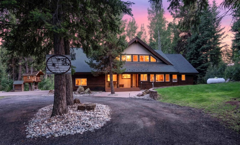 A spacious, pet-friendly five-bedroom mountain retreat along Lake Fork Creek, just 5 miles from downtown McCall. Surrounded by pines, this cabin sleeps up to 12 and features an indoor hot tub, two main-level primary suites, a game loft with foosball, and a large deck overlooking the river. Enjoy a creekside fire pit, outdoor seating, and plenty of space for gathering, with convenient access to year-round recreation.