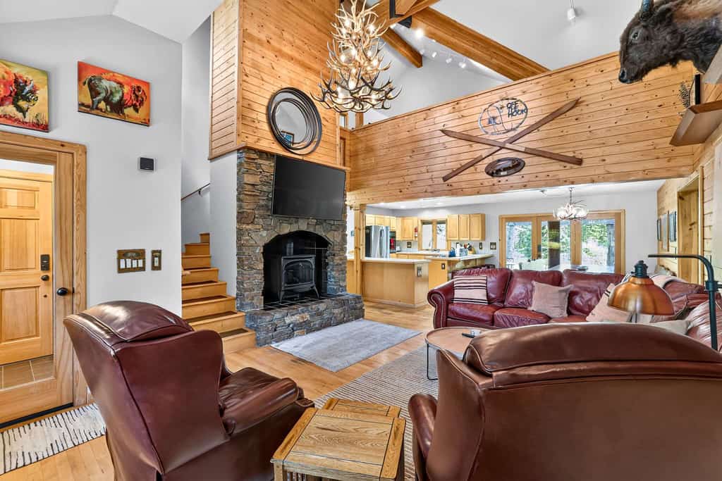 A spacious, pet-friendly five-bedroom mountain retreat along Lake Fork Creek, just 5 miles from downtown McCall. Surrounded by pines, this cabin sleeps up to 12 and features an indoor hot tub, two main-level primary suites, a game loft with foosball, and a large deck overlooking the river. Enjoy a creekside fire pit, outdoor seating, and plenty of space for gathering, with convenient access to year-round recreation.